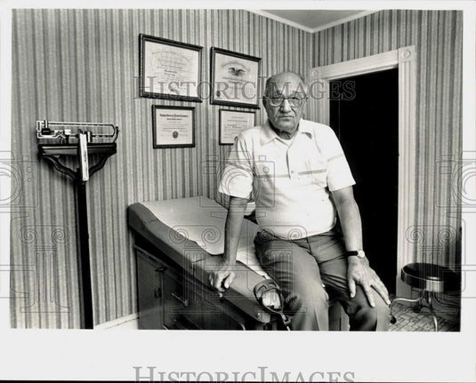 Press Photo Dr. Edward Dill sits in his Ludlow examining room. - sra22432- Historic Images