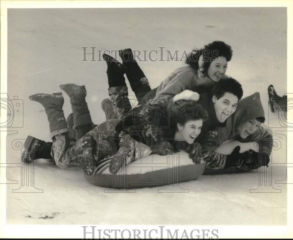 1988 Press Photo Friends Snow Sledding at Longbranch Park in Liverpool- Historic Images