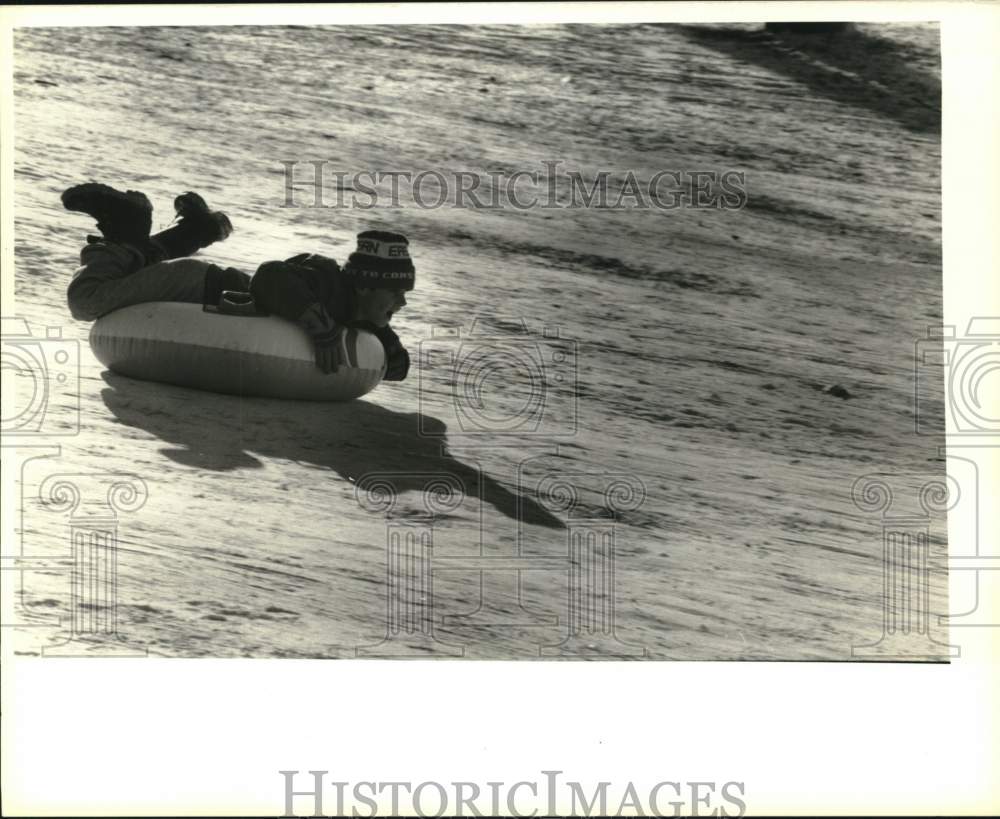 1988 Press Photo Billy Komanecky Sliding Down Snowy Hill at Casey Park in Auburn- Historic Images