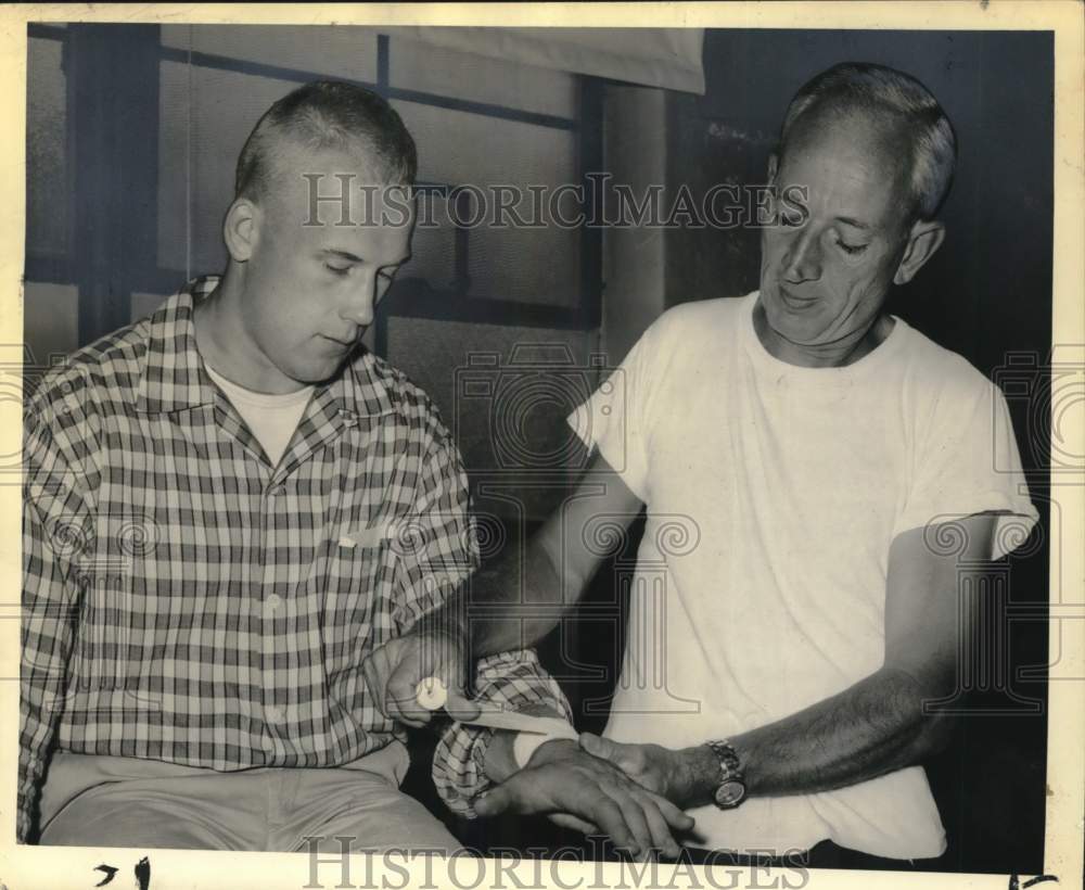 1957 Press Photo Syracuse University Trainer Julie Reichel with Football Player- Historic Images