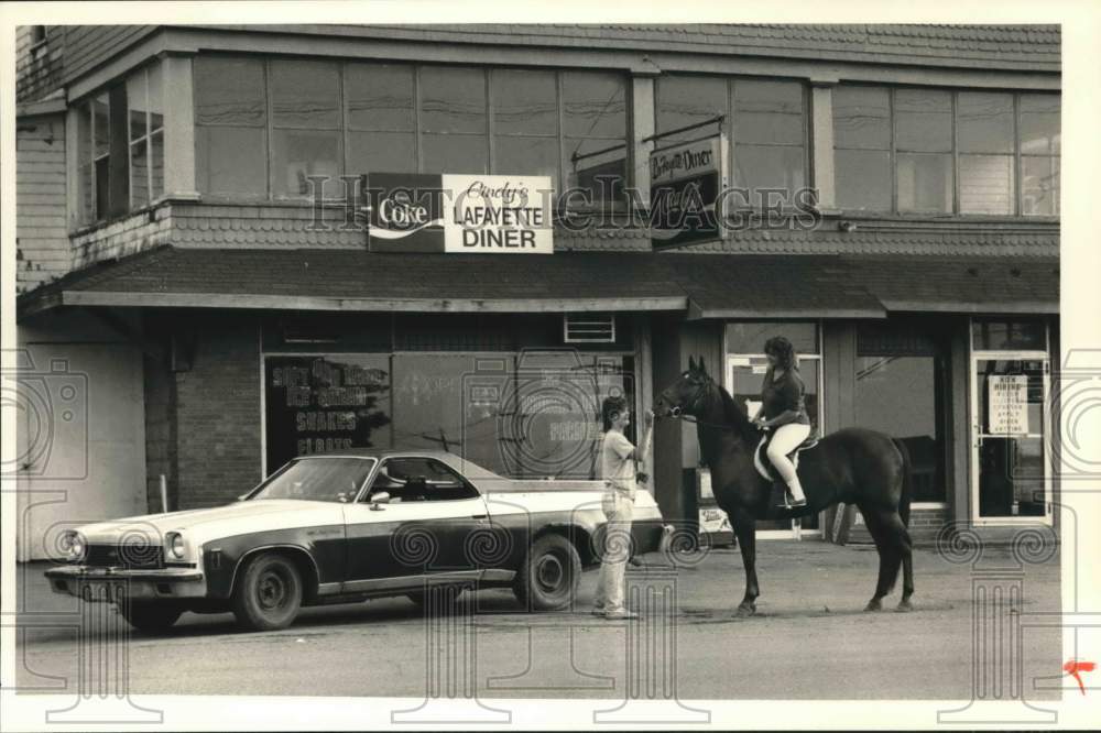 1988 Press Photo Kathy Butkins on Horse at Cindy&#39;s LaFayette Diner in New York- Historic Images