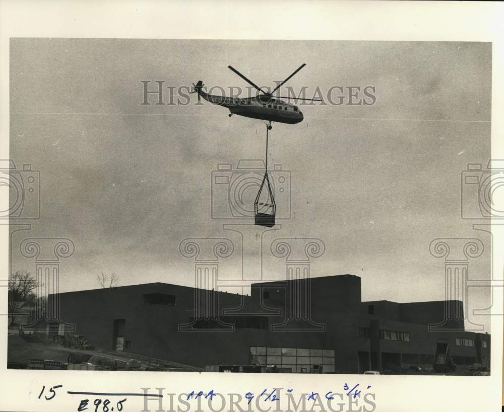 1975 Press Photo Helicopter Delivers Air Conditioner Over Fowler High School