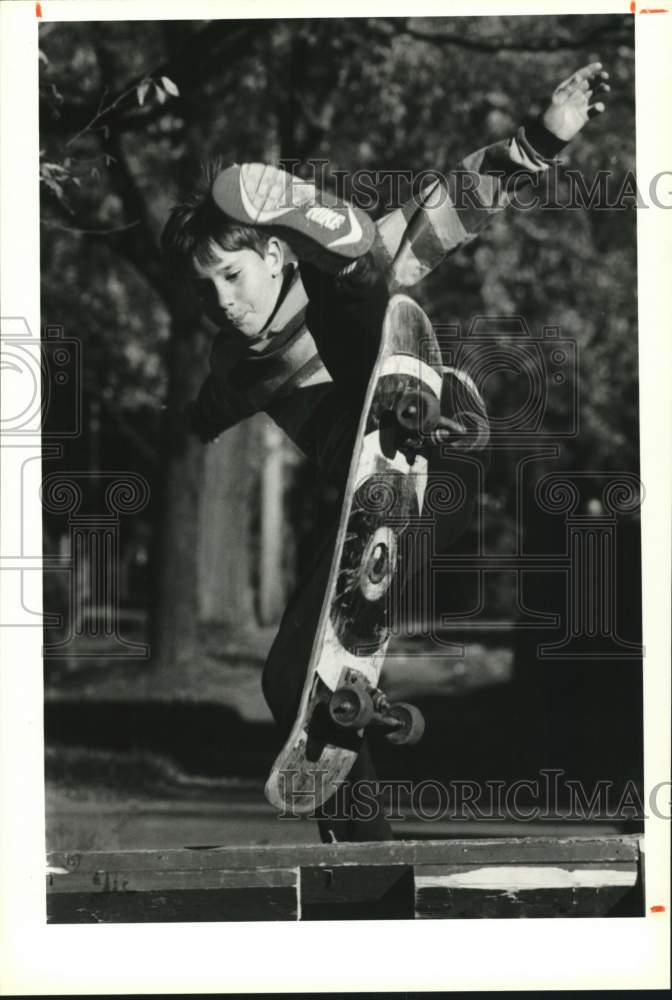 1990 Press Photo Jesse Miller Flies Over Jump on Skateboard in Oneida, New York- Historic Images