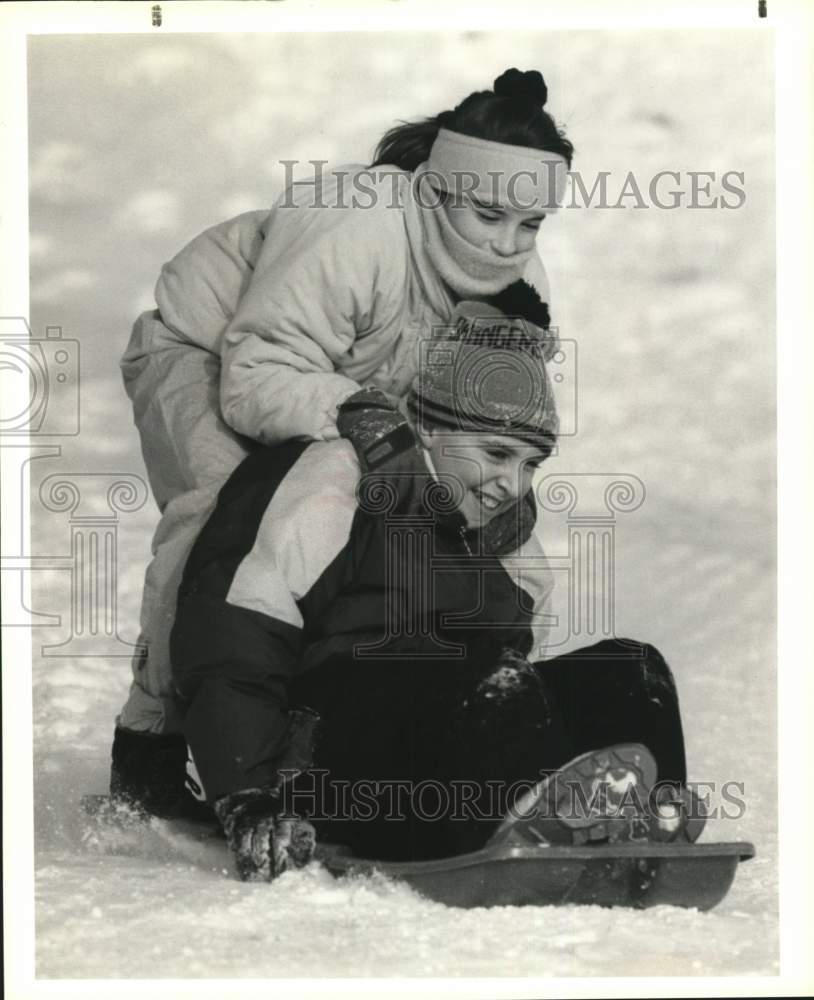 1990 Press Photo Chad Shoemaker and Friend Sled in Snow at Tully High School- Historic Images