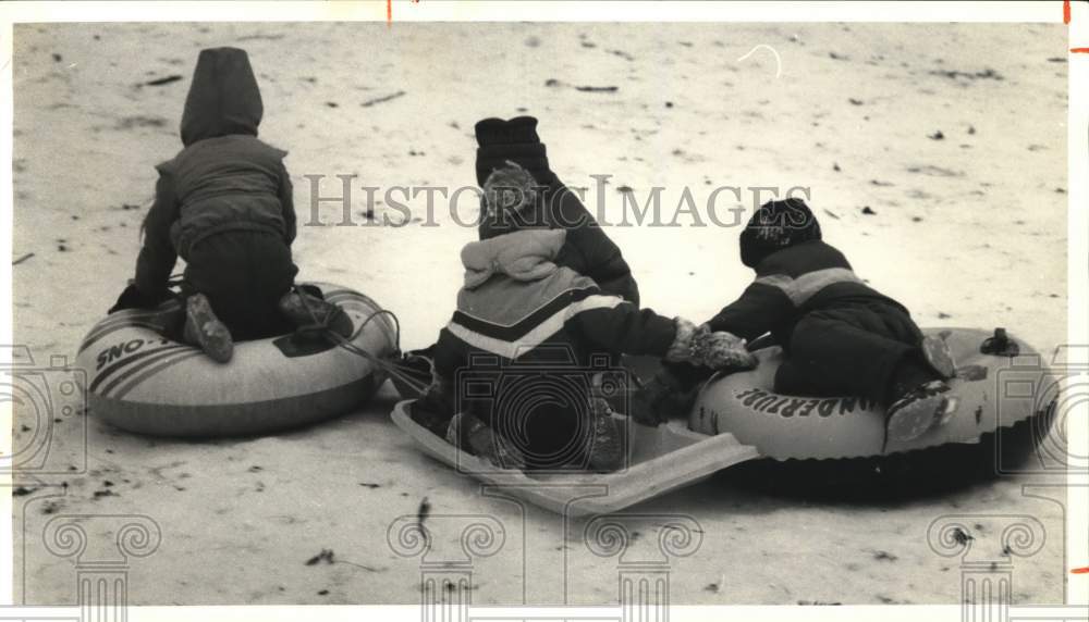 1987 Press Photo Friends Snow Sledding at Allen Park in Oneida, New York- Historic Images