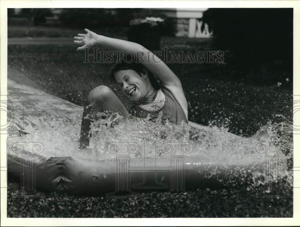 1989 Press Photo Audrey McGraw on Water Slide at Court Street Home in Syracuse- Historic Images