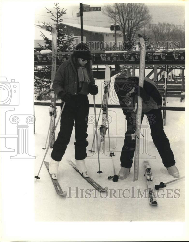 1987 Press Photo Mandy Coomer and Jason Chan put on Skis at Greek Peak, New York- Historic Images