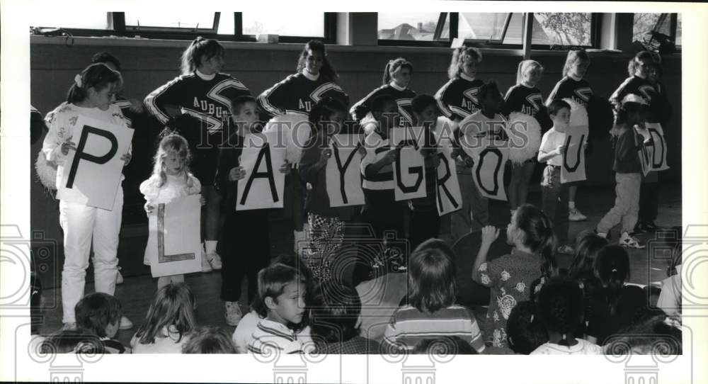 1991 Press Photo Auburn High School Cheerleading Squad with Playground Placards- Historic Images