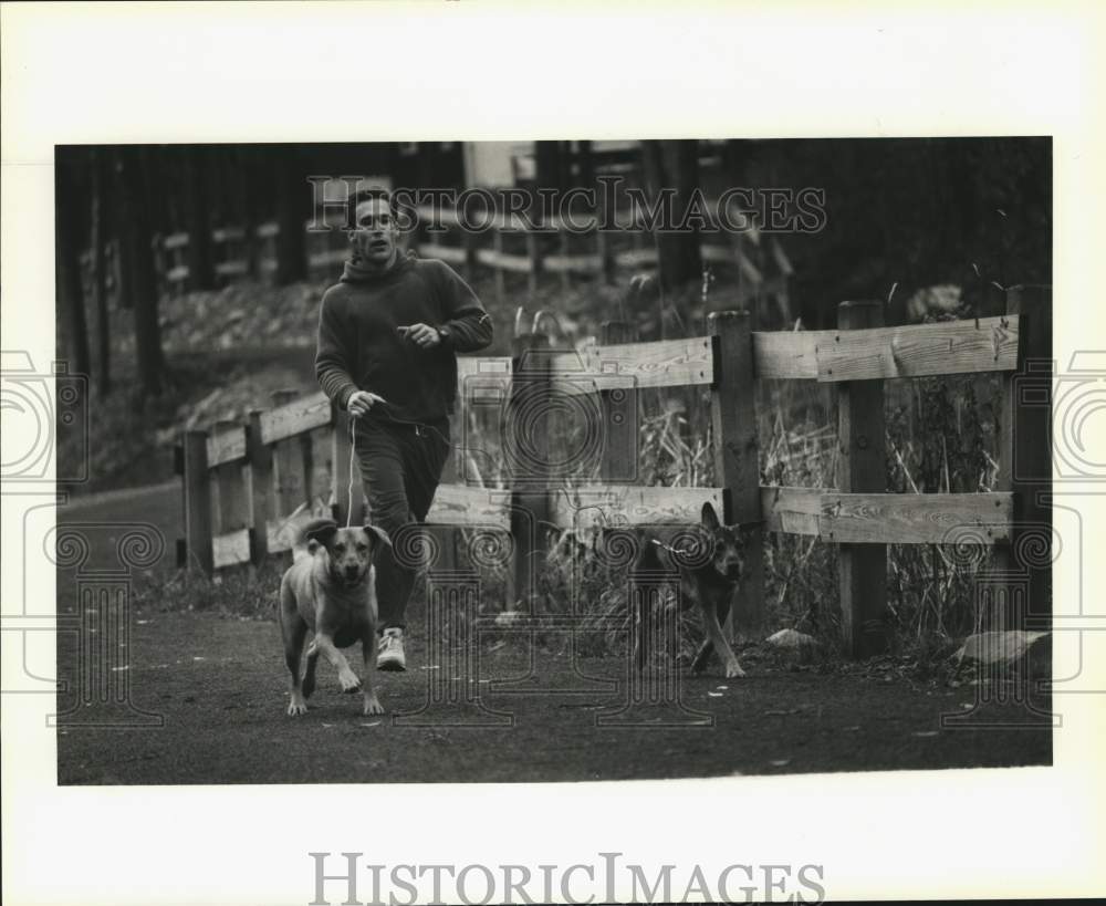 1990 Press Photo Greg Topping with Dogs on Mill Street in Watertown, New York- Historic Images