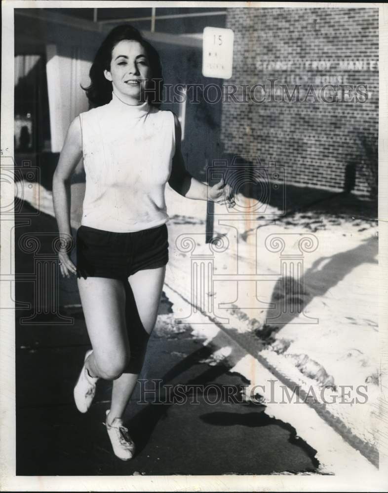 1967 Press Photo Fashion Model Kathy Switzer runs outside in Snow - sya90785- Historic Images