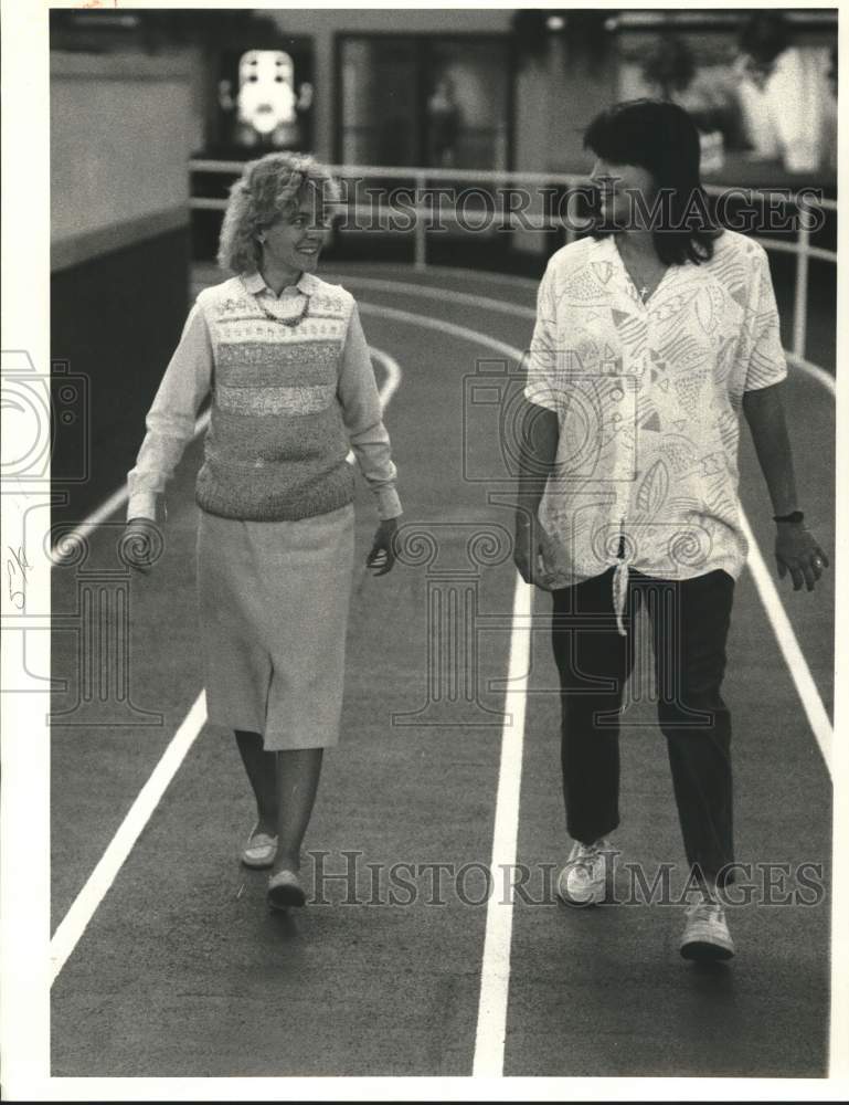 1987 Press Photo Sue Sandstrom & Trina Tremblay Walk on Track at Sundown, DeWitt- Historic Images