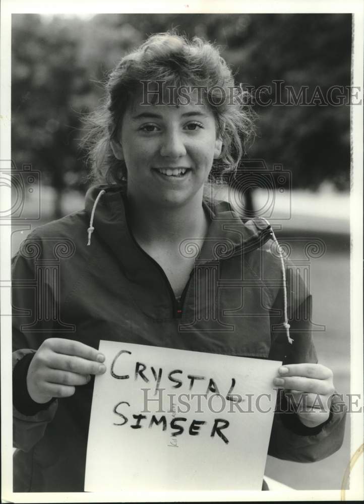 1989 Press Photo Crystal Simser holds up a sign with her name on it - syp00040- Historic Images