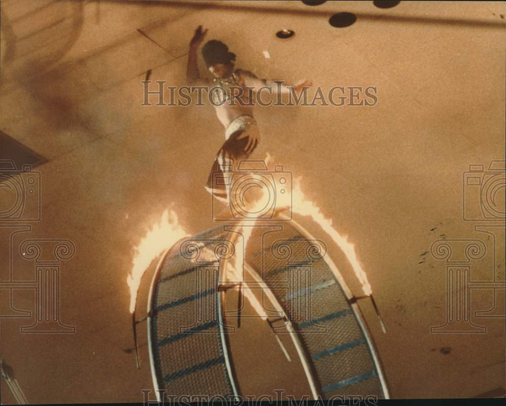 Press Photo The Oneco's Shrine Circus artist walks on flaming giant space wheel- Historic Images
