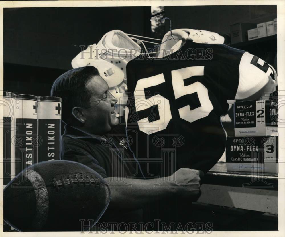 1963 Press Photo Syracuse Stormers football trainer looks over equipment- Historic Images