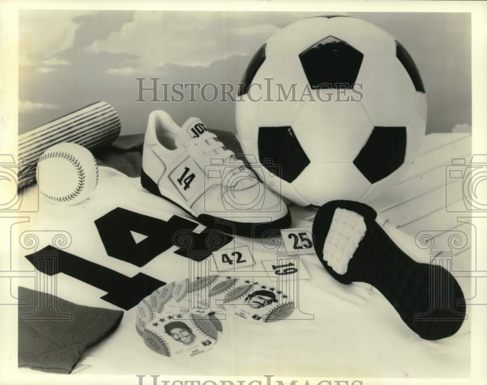 1985 Press Photo Photo of soccer ball, tennis shoes, #14 jersey, bat & baseball- Historic Images