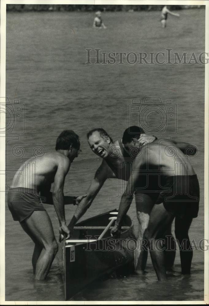 Press Photo Three men prepare to launch canoe in the Oswego Challenge in NY- Historic Images
