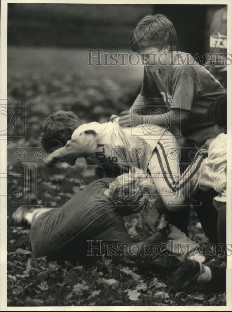 Press Photo Kids play football at Coe and Broadway in Oneida, New York- Historic Images