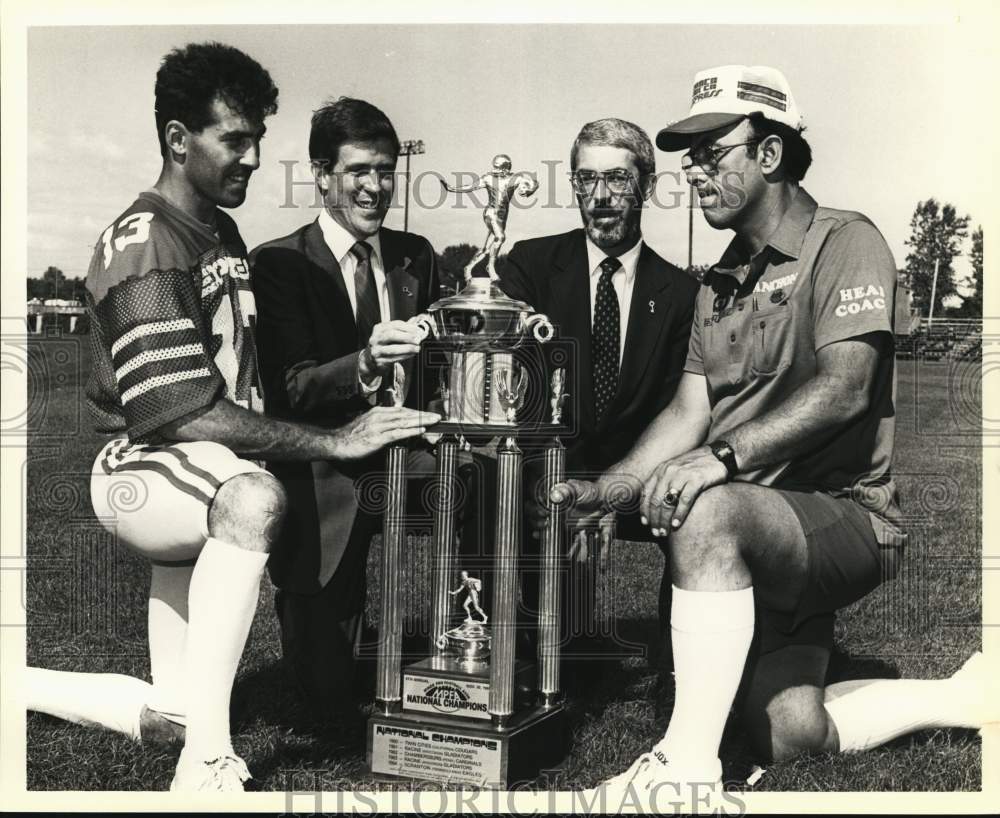 1986 Press Photo Syracuse Express Football Team Members with Trophy- Historic Images