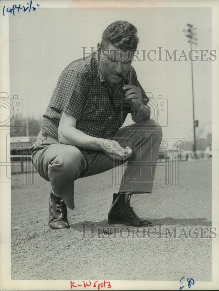 1962 Press Photo Jack Wiswall examines race course at Saratoga Springs, New York- Historic Images