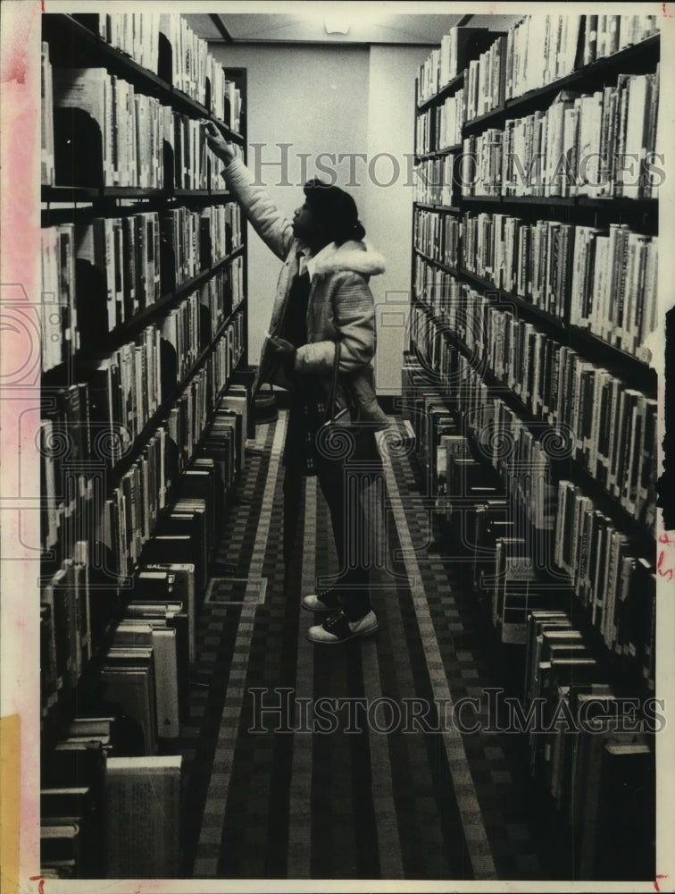 1979 Press Photo Lori Williams looks for a book in stacks at Albany, NY library- Historic Images