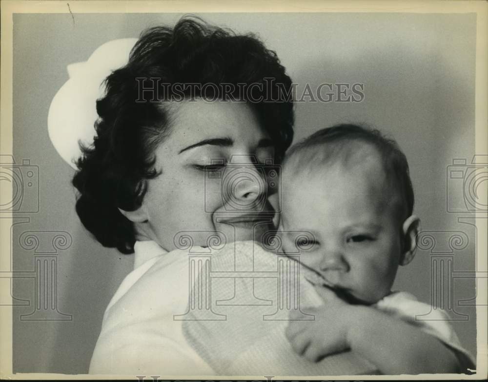 1962 Press Photo Nurse holding a baby in Albany, New York - tua15341- Historic Images