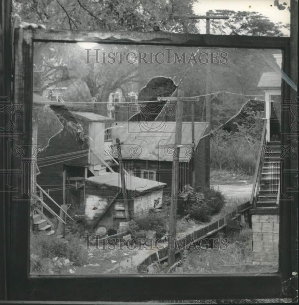 1957 Press Photo View of alley through broken window in Watervliet, New York