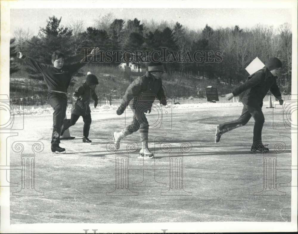 Press Photo Kids race on ice skates during Sand Lake Winter Carnival, New York- Historic Images
