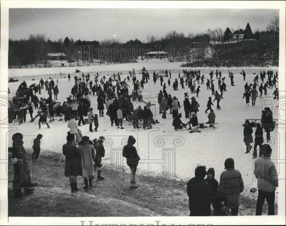 Press Photo Ice skaters on pond during Sand Lake Winter Carnival in New York- Historic Images