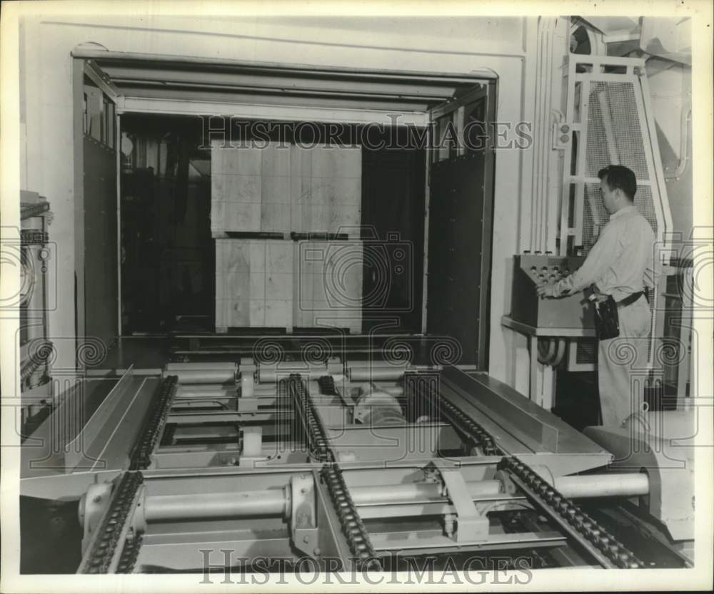 1958 Press Photo Crewman loads cargo onto cruise ship elevator in New York