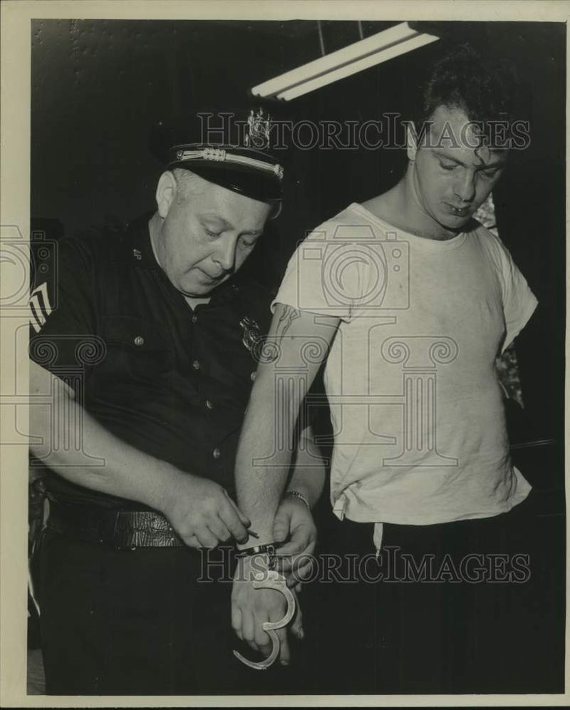 Load image into Gallery viewer, 1961 Press Photo John Seebode, 22, Catskill, NY is handcuffed by police officer
