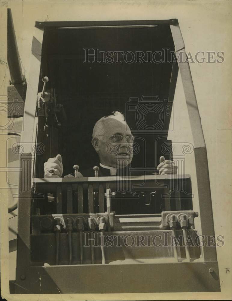 1963 Press Photo Bishop William A Scully, operates cab of steam shovel