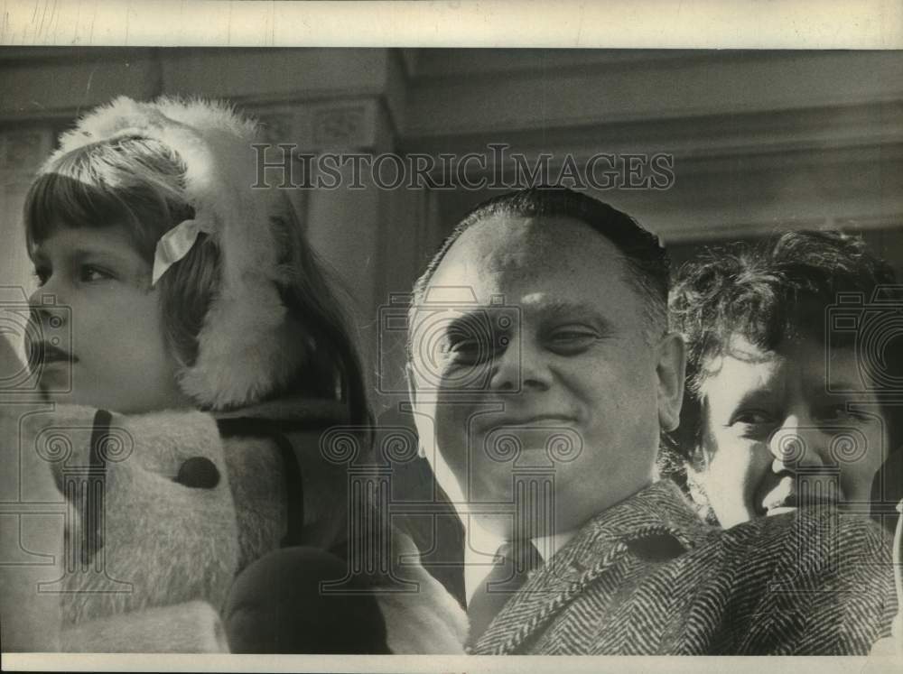1967 Press Photo Michael Liuni with young girl and woman standing behind him