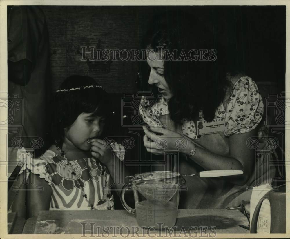 1973 Press Photo Cheryl Paguette gives food sample to young girl in New York