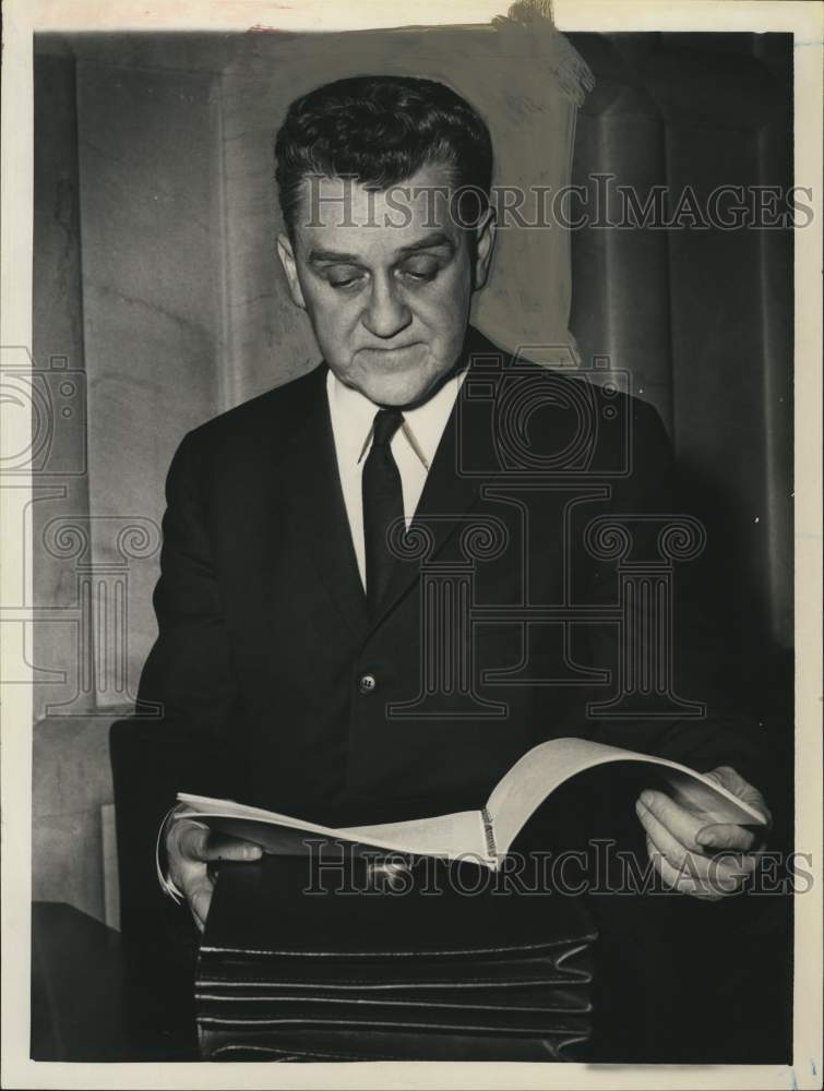 1964 Press Photo John J O'Connell, State Liquor Authority, looks over notebook