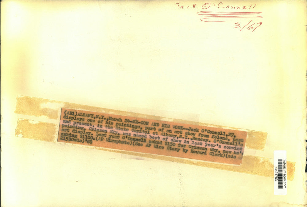 1969 Press Photo Jack O'Connell sits next to his painting at exhibit in Albany