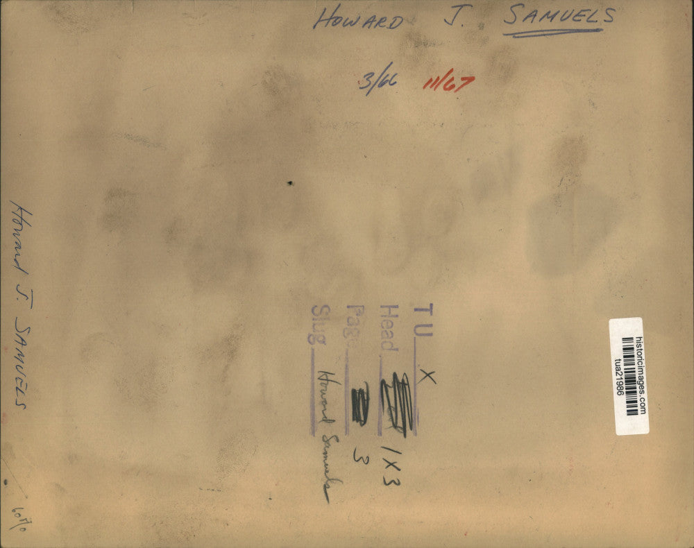 1966 Press Photo Howard J Samuels sits behind desk and reads papers - tua21986