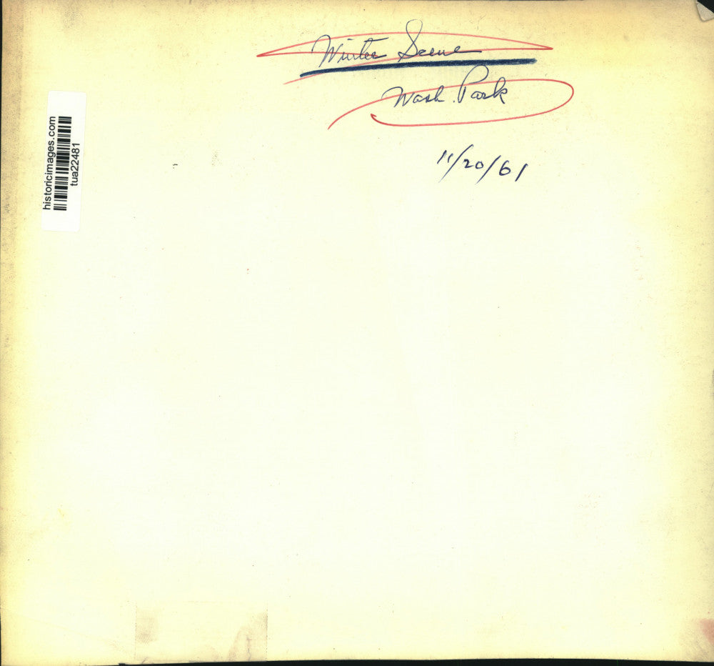 1961 Press Photo View down river, bridge in background as snow covers grounds