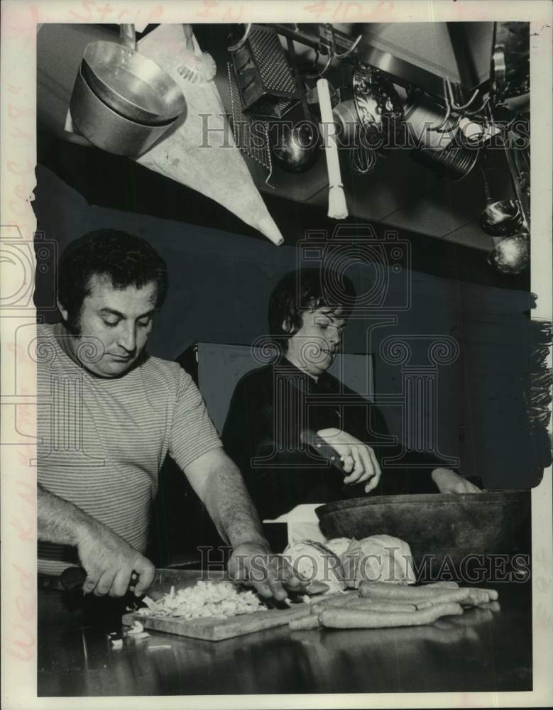 1973 Press Photo Mr and Mrs Sol Seras chop food in industrial kitchen