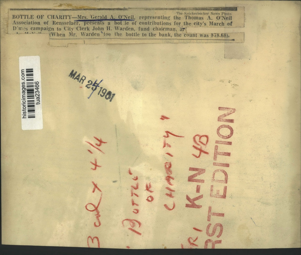 1961 Press Photo Mrs Gerald O'Neil presents bottle of contribution for charity