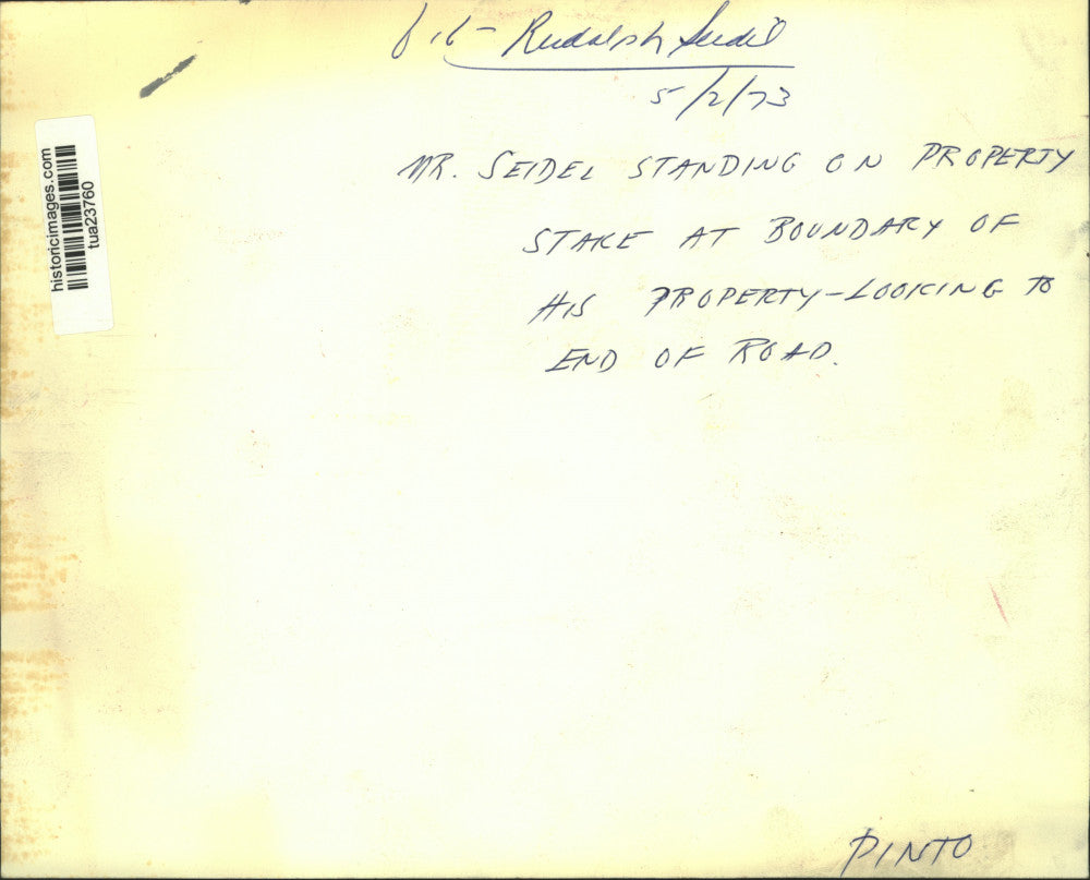 1973 Press Photo Rudolph Seidel stands on property stake at boundary of his home