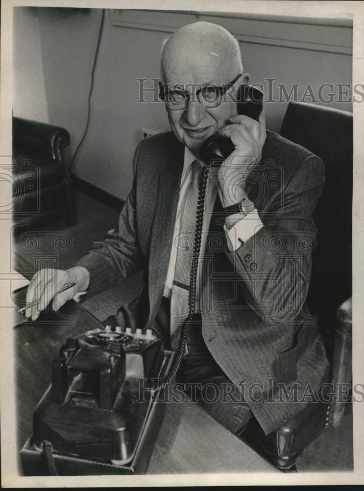1968 Press Photo Adolf Lorch sits behind desk and talks on the telephone