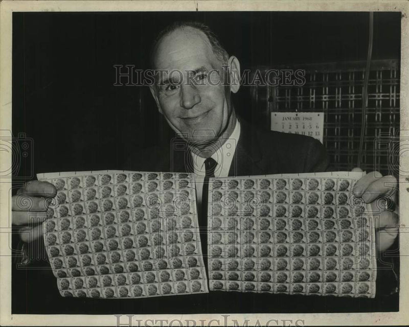 Load image into Gallery viewer, 1968 Press Photo John Schumaker with sheets of stamps in Albany, New York

