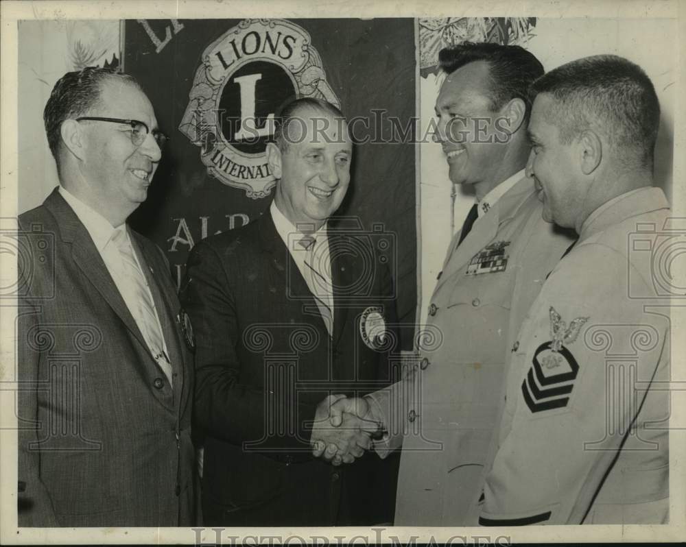 1964 Press Photo Frank J Luddy shakes hands with military officers at Lions Club