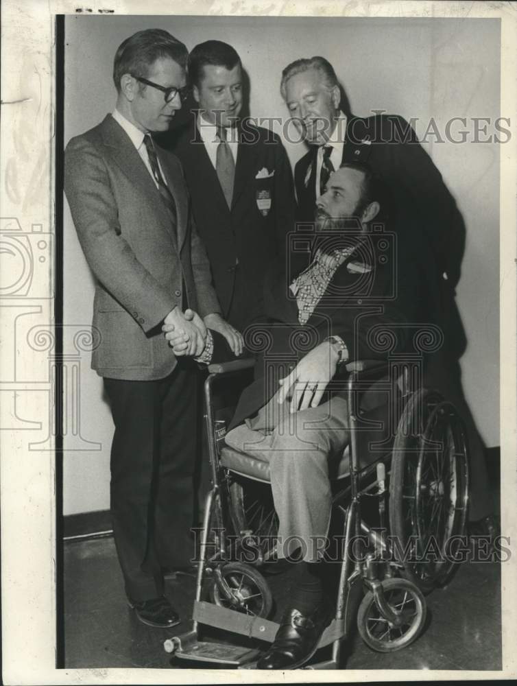 Load image into Gallery viewer, 1974 Press Photo Cerebral Palsy officials greet man in wheelchair in New York
