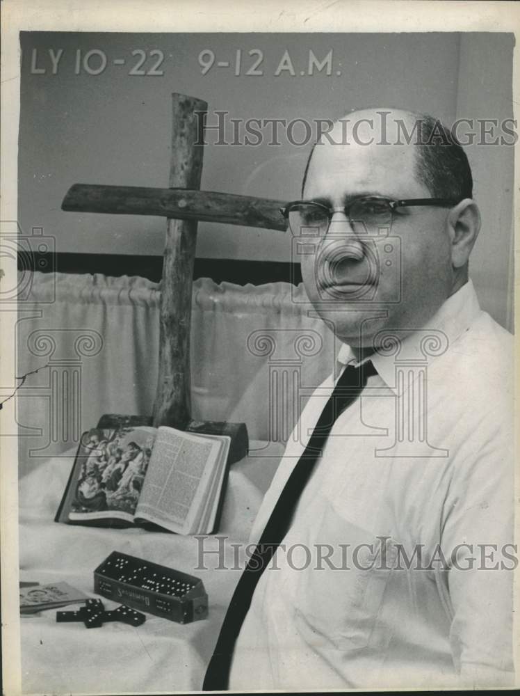 1967 Press Photo Reverend Angelo J Mongiore stands by display of religious items
