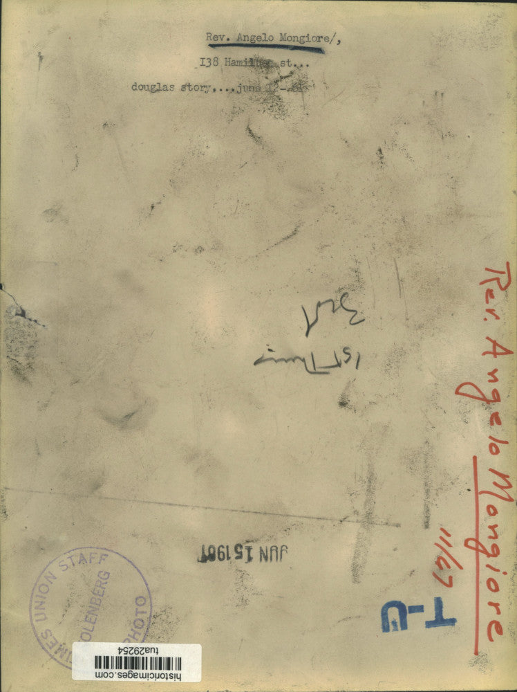 1967 Press Photo Reverend Angelo J Mongiore stands by display of religious items