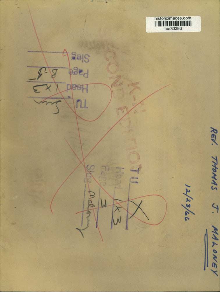 1966 Press Photo Reverend Thomas J Maloney sits behind desk writing letter