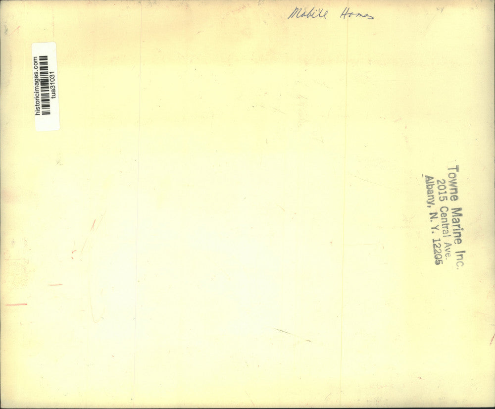 Press Photo Station wagon tows travel trailer on road near rural farm