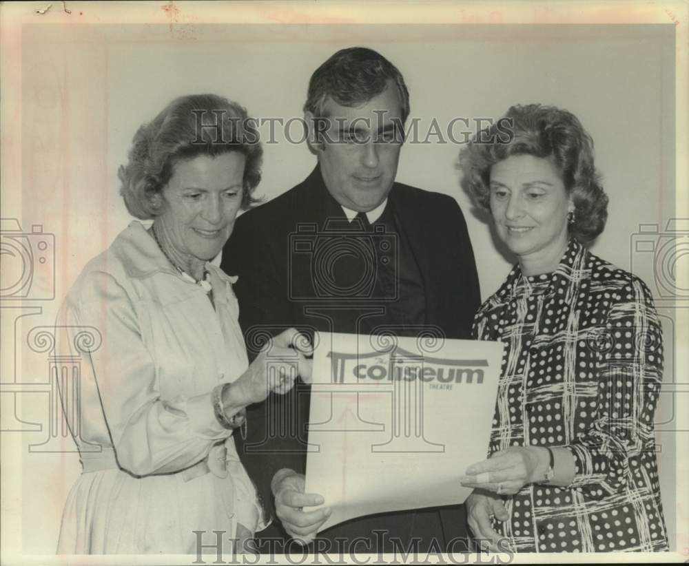 1976 Press Photo Group looks over program from Coliseum Theatre in New York