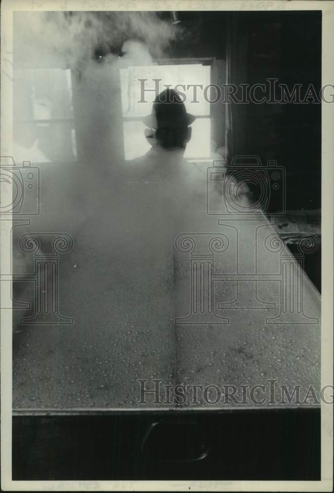 Load image into Gallery viewer, 1972 Press Photo Man watches steam evaporate from pot during Maple Sugaring
